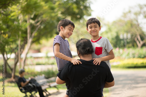 Father and sons walking together in the park © wckiw