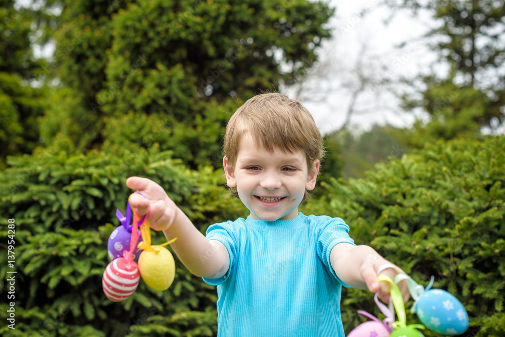 Different color Easter Eggs in a child's hands- egg hunt Different color Easter Eggs in a child's hands- egg hunt