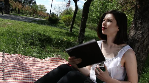 Young lovely girl reading book in park city, 4K, UHD, UltraHD