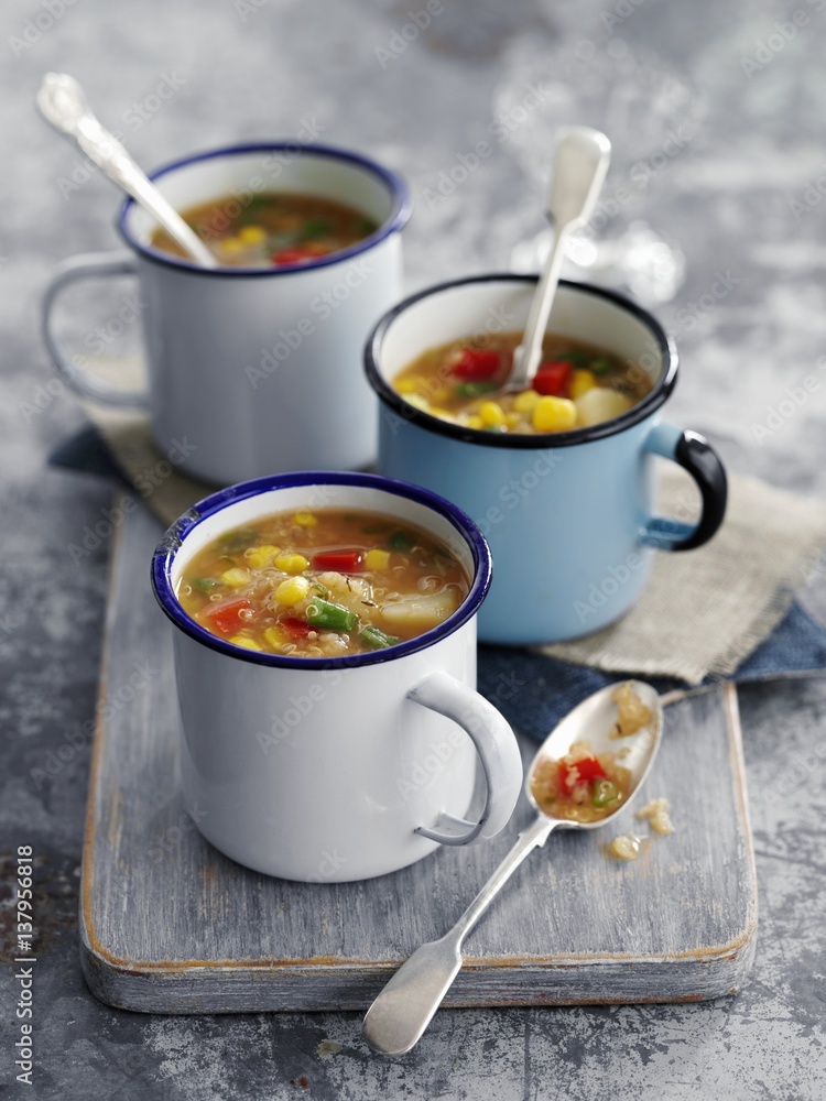 Thick quinoa and sweetcorn soup in enamel cups Thick quinoa and sweetcorn soup in enamel cups