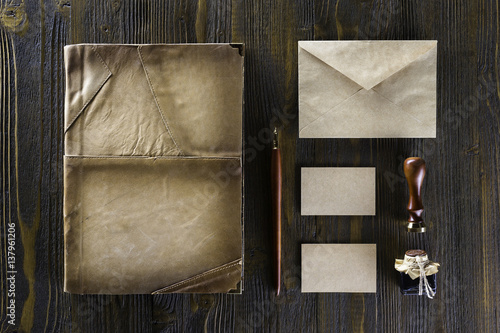 Valokuvatapetti Mockup of vintage stationery set including folio book, business cards and envelope at wooden table background