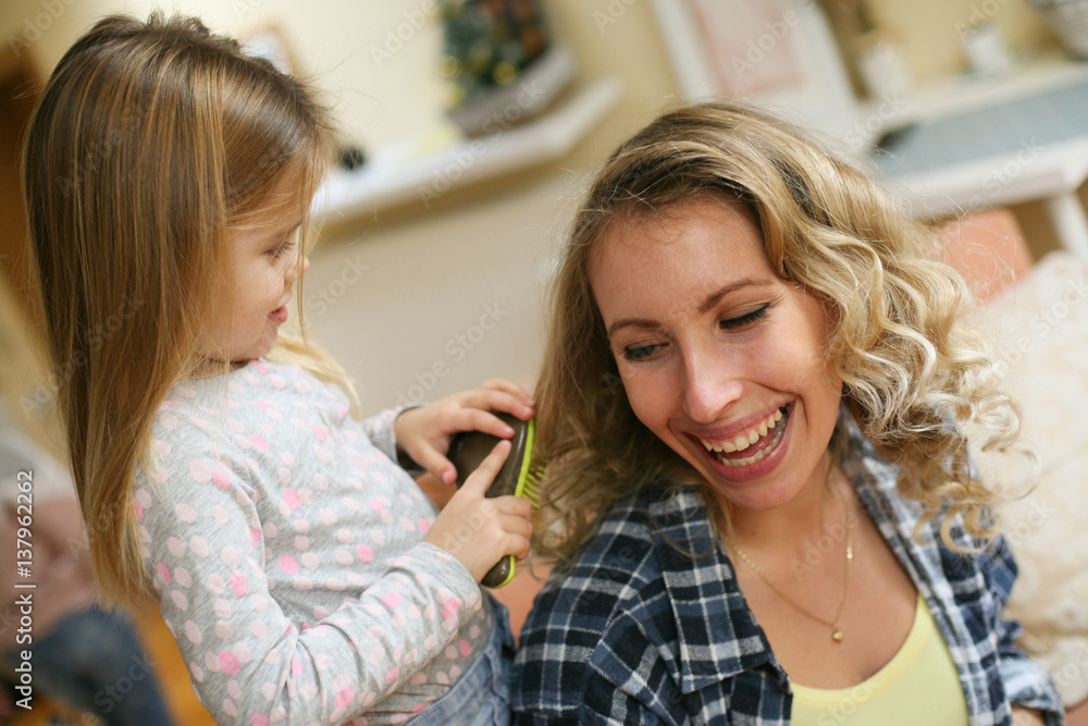 Daughter combing mothers hair. Daughter combing mothers hair.