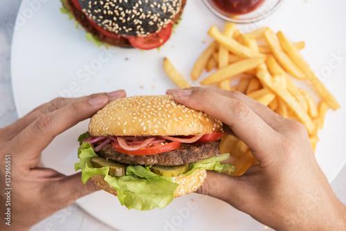Man eating burgers