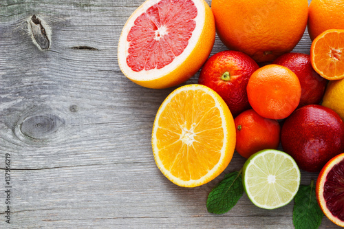 Fototapeta Naklejka Na Ścianę i Meble -  Lemon,red orange, orange, grapefruit,  lime, tangerine on old wooden table. Place for text. Background.