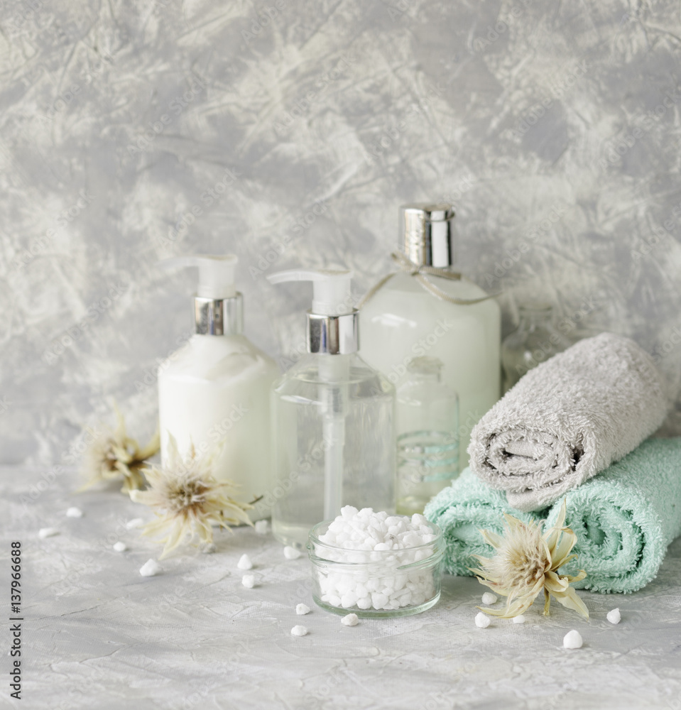 Spa set on a white marble table with a stack of towels, selective focus Spa set on a white marble table with a stack of towels, selective focus