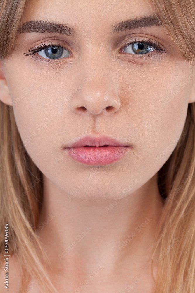 Closeup portrait of young beautiful woman blond girl with long straight hair with natural makeup. Vogue style portrait. Hairstyle and skincare and cosmetics concept Closeup portrait of young beautiful woman blond girl with long straight hair with natural makeup. Vogue style portrait. Hairstyle and skincare and cosmetics concept