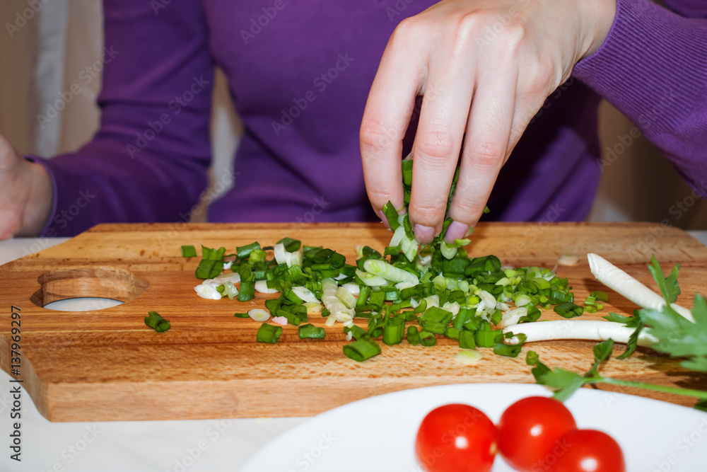 Beautiful female fingers got chopped for salad green onions Beautiful female fingers got chopped for salad green onions