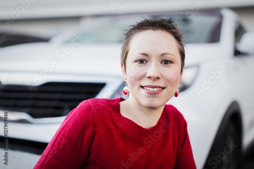 A young woman portrait with her car.