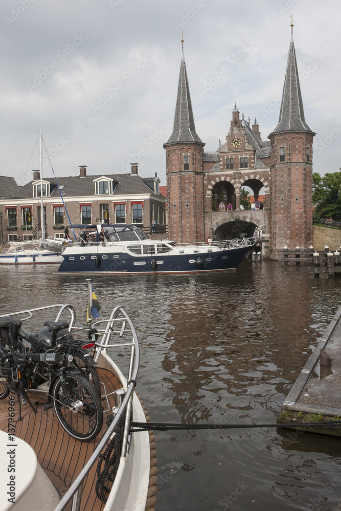 City of Sneek the Netherlands. Canal, boat and Watergate with towers. Waterpoort. Friesland