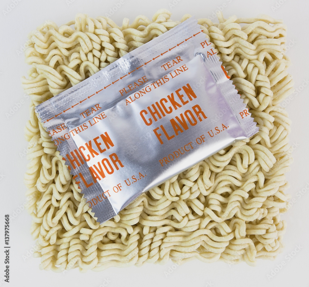 Uncooked ramen noodles with chicken flavor foil packet. Stock