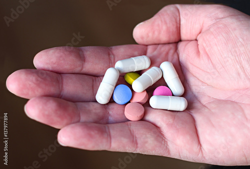 Pills and another drugs for illegal doping manipulations. Pharmacy antibiotic and antidepressant in a hand.