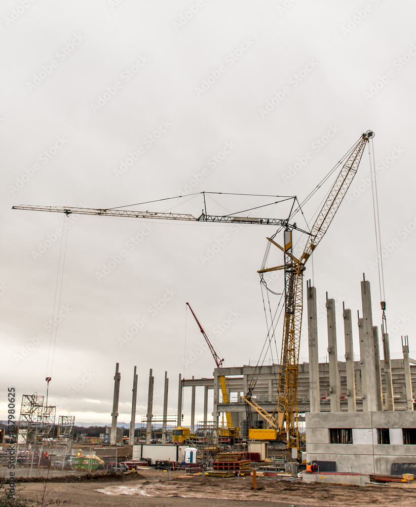 Fototapeta premium concrete construction yard building site crane cloudy sky background