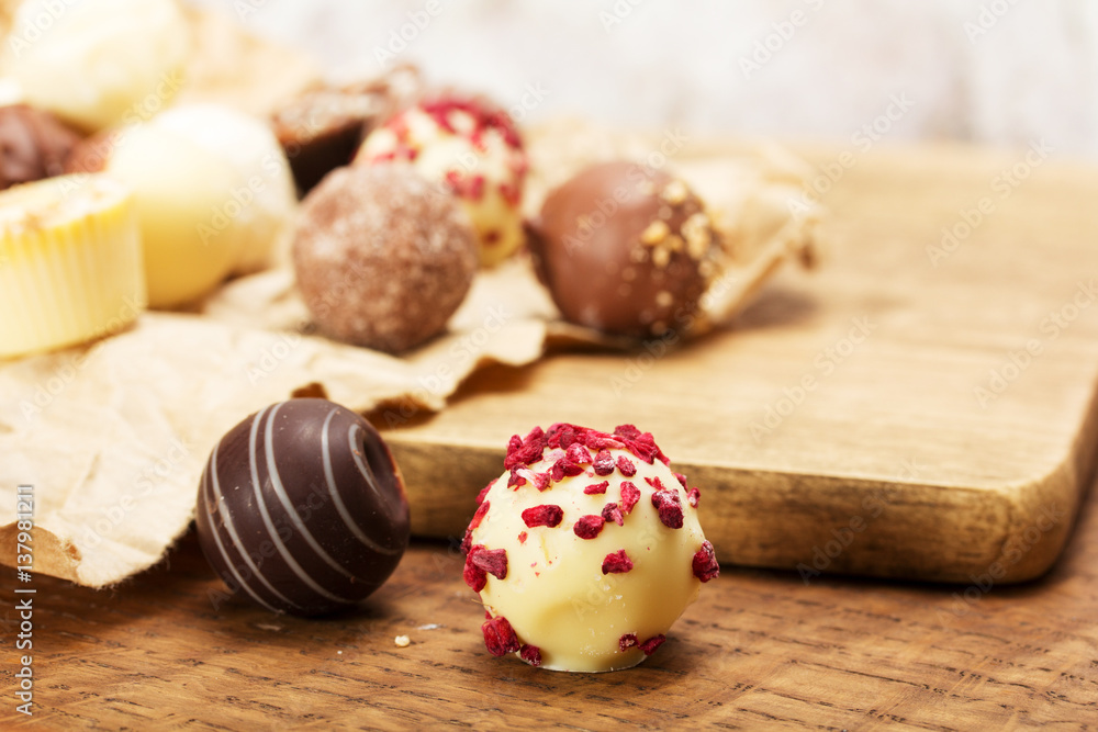 Selection of delicious chocolates on a rustic background Selection of delicious chocolates on a rustic background