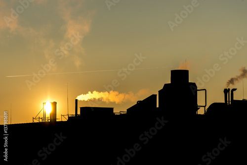 silhuette Industrial factory smoke from smokestacks over colorful sunset sky industry photo
