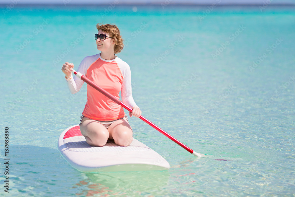 woman stand up paddleboarding