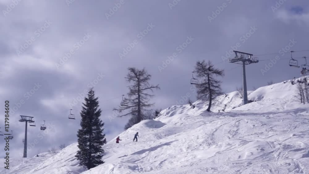 People skiing on mountain slopes in ski resort, unrecognizable skiers enjoying winter activity on snow People skiing on mountain slopes in ski resort, unrecognizable skiers enjoying winter activity on snow