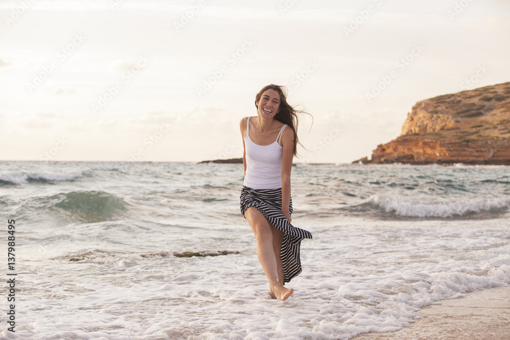 romantic cheerful woman playing and laughing in the beach