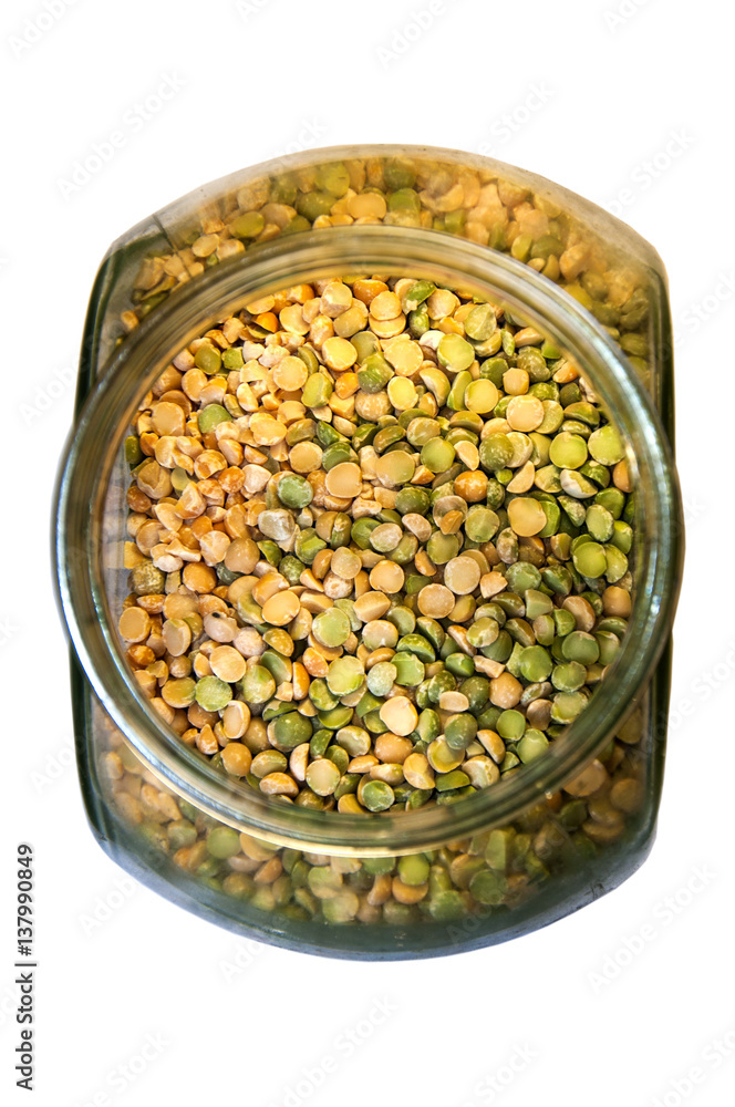 Foodstuff: mixture of dry peas in a glass container over white background Foodstuff: mixture of dry peas in a glass container over white background