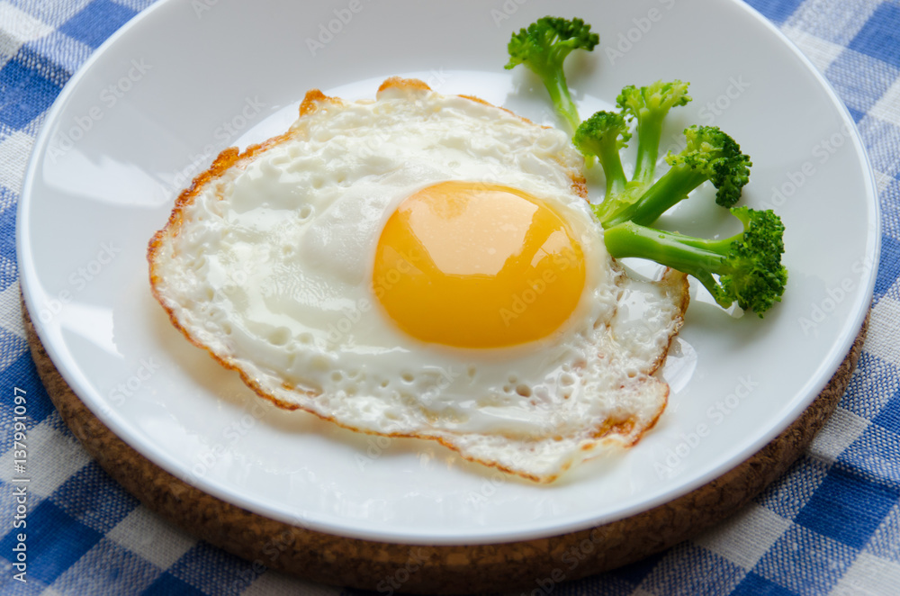 Scrambled eggs served on a platter with broccoli Scrambled eggs served on a platter with broccoli