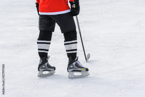 hockey player with a stick standing on ice