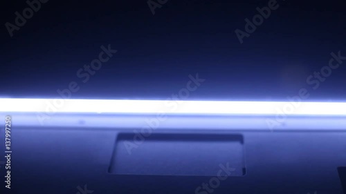 Neon photo scanner lamp moves from top to bottom