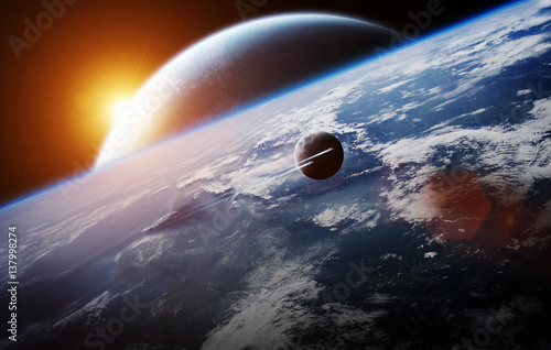 Fototapeta Naklejka Na Ścianę i Meble -  Sunrise over distant planet system in space 3D rendering elements of this image furnished by NASA