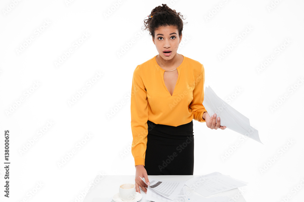 Incredible young curly african lady standing with documents Incredible young curly african lady standing with documents
