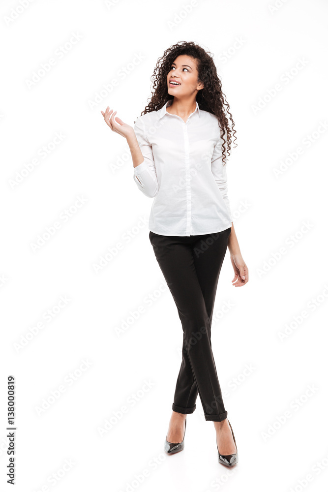 Attractive young curly african woman posing over white background Attractive young curly african woman posing over white background