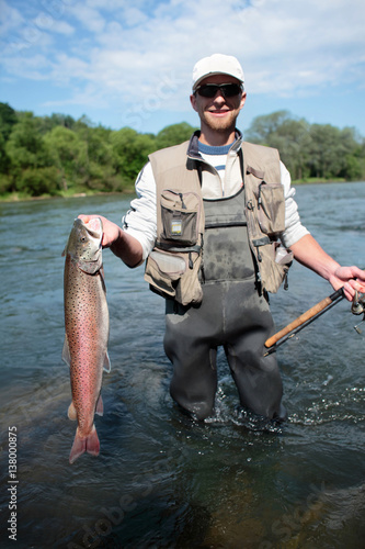 Danube salmon/ Fisherman presenting huchen. Spin fishing in San River, Sub-Carpathian region. The huchen is endemic to the Danube basin in Europe and also occurs in Dunajec River.