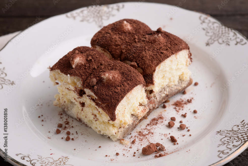 Portion of tiramisu on decorated saucer Portion of tiramisu on decorated saucer
