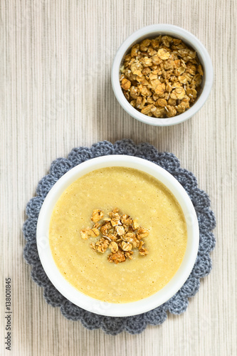 Fresh homemade sweet rhubarb mousse dessert with crunchy granola on top served in bowl, photographed overhead with natural light (Selective Focus, Focus on the top of the dessert)