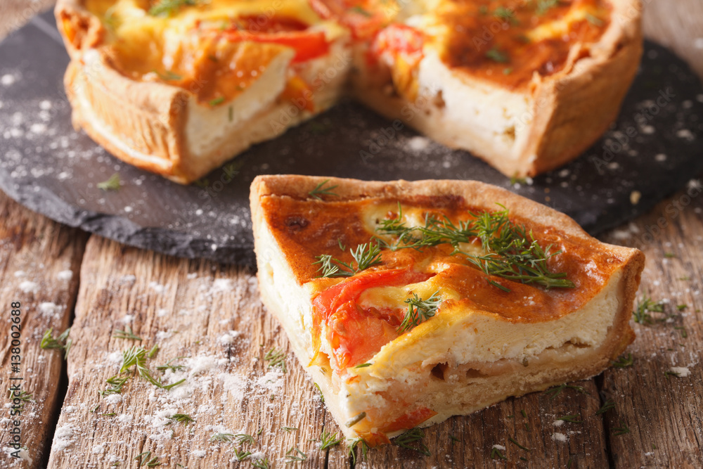 Freshly sliced pie with feta, tomatoes and herbs closeup. horizontal