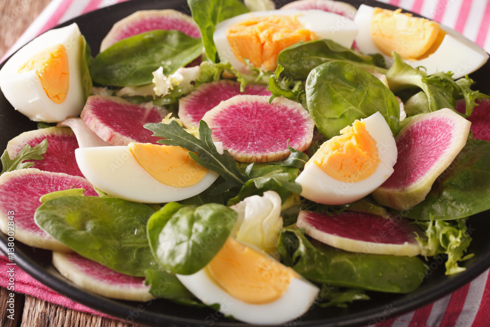 Salad with radishes, eggs, spinach and lettuce mix close-up. horizontal Salad with radishes, eggs, spinach and lettuce mix close-up. horizontal