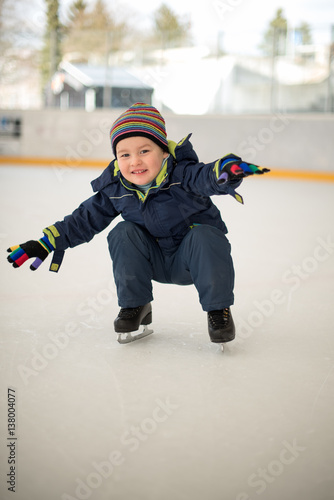 Winter sport. Small boy skating on ice