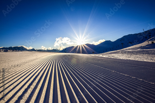 Fotografie Close up of a freshly prepared skiing slope in the evening sun in the Zillertal skiing area in Austria, Europe