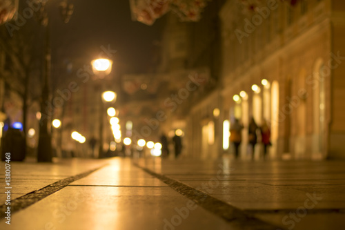 Blurred background. Blurred people walking through city street. winter night