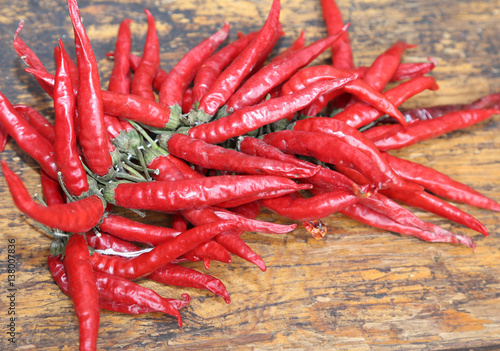 red hot peppers on wooden table at market