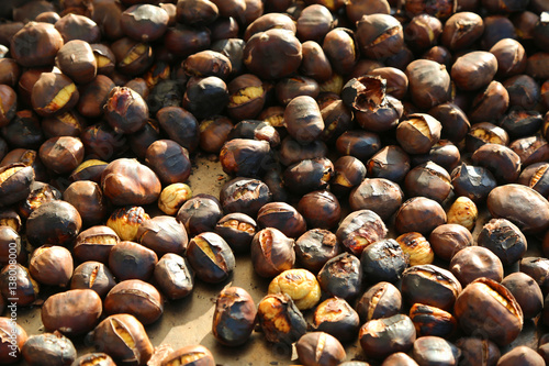 many roasted chestnuts for sale in the stall in the street