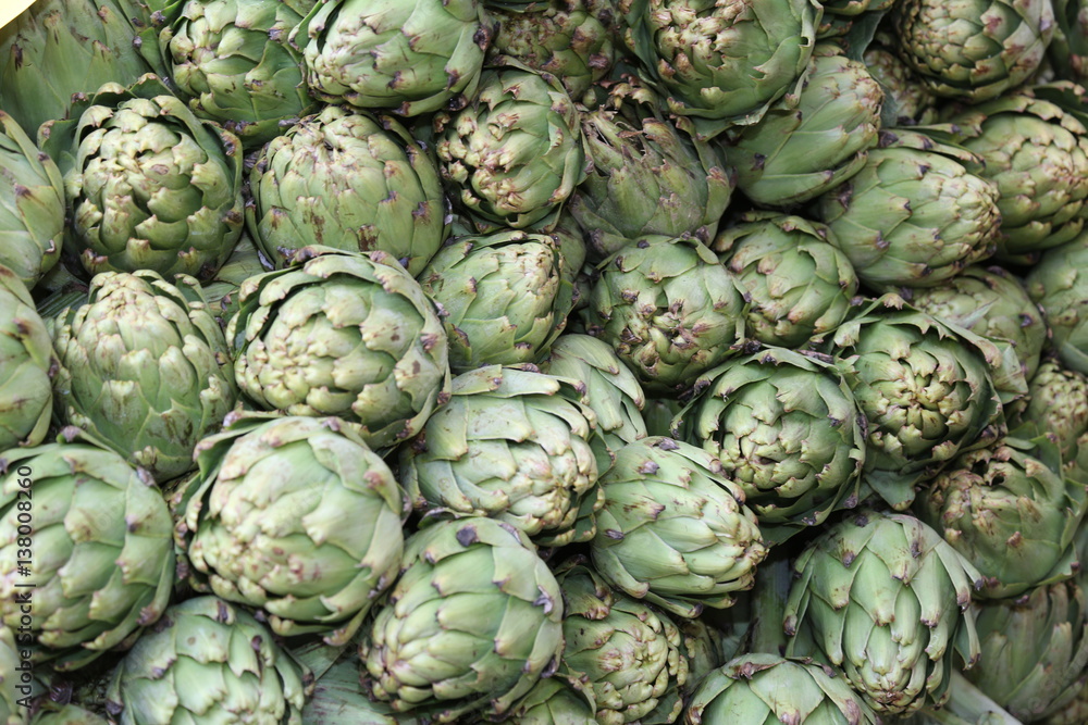 Fototapeta premium green background of artichokes for sale