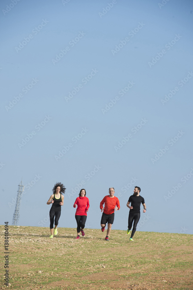Group of people running together outside, preparing for the marathon Group of people running together outside, preparing for the marathon