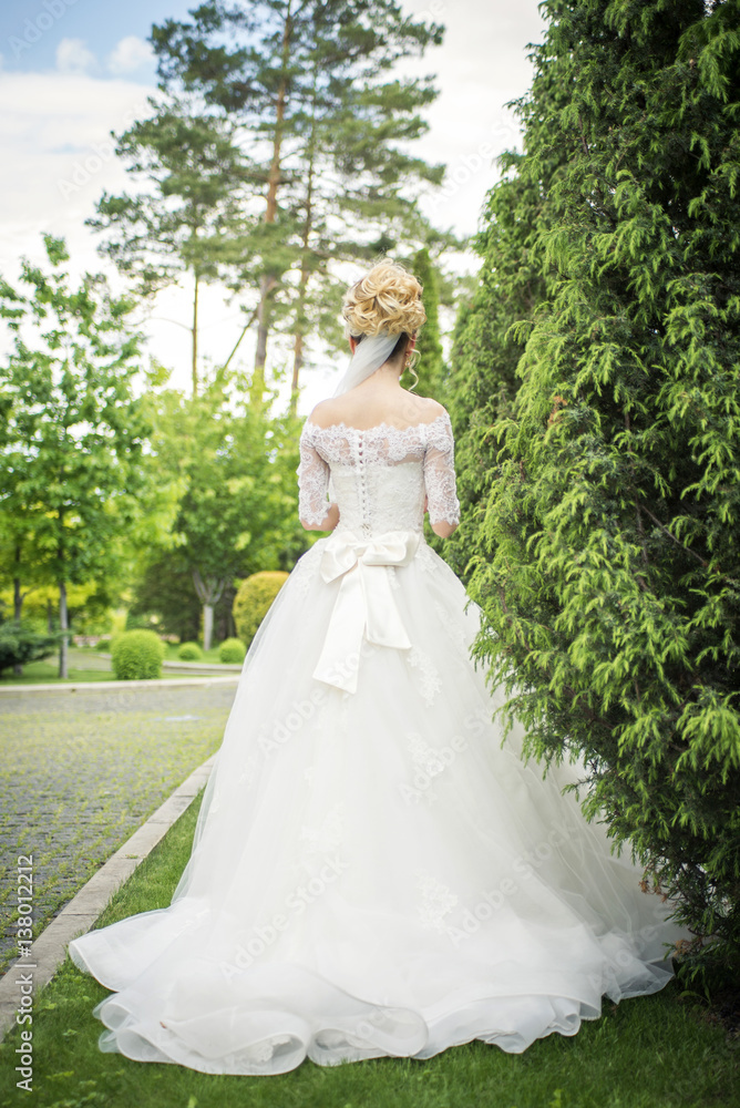 girl in wedding dress in park
