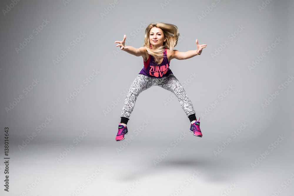 Sporty young woman jumping isolated on white background Sporty young woman jumping isolated on white background