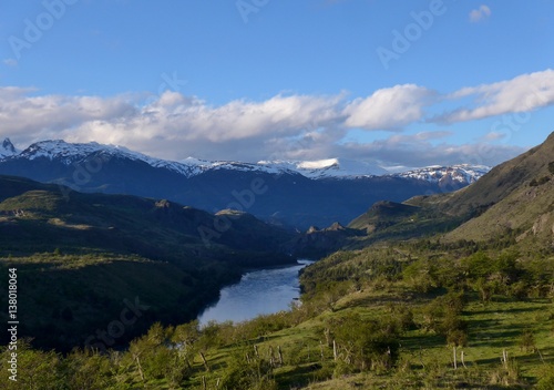 River flowing through a lush green mountainous landscape in Patagonia.  © mat_millard