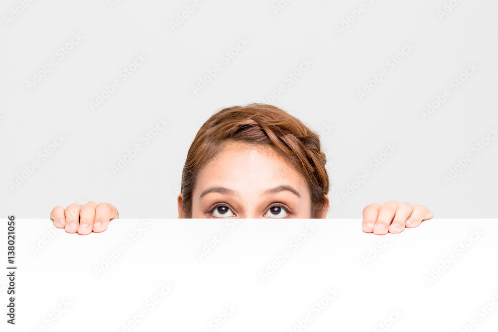 young girl staring something on the white table