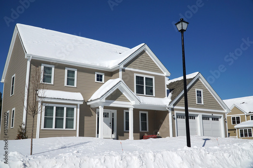 house in residential area after snow