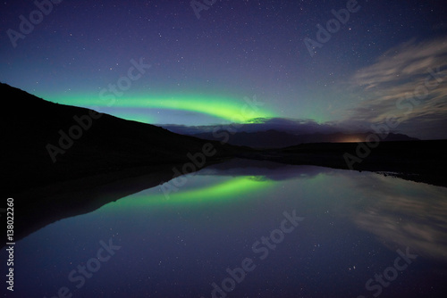 Reflections of aurora borealis over the jokulsarlon lagoon, iceland. image noise due high ISO © hafizanwar