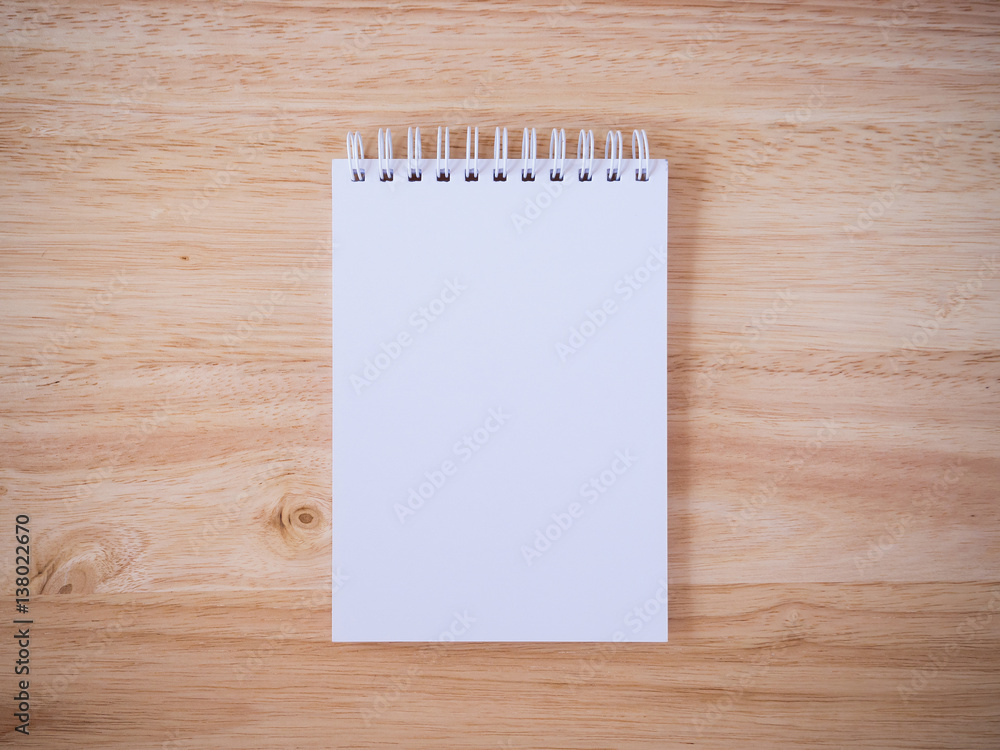 Notepad on the wooden desk table Notepad on the wooden desk table