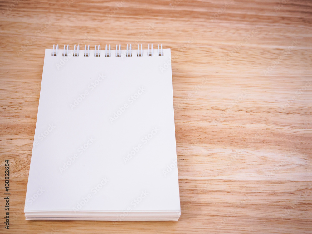 Notepad on the wooden desk table Notepad on the wooden desk table