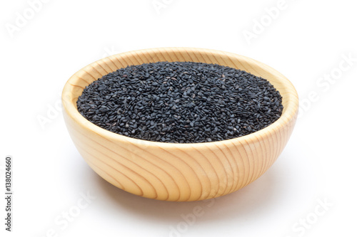 Black sesame seeds in wooden bowl