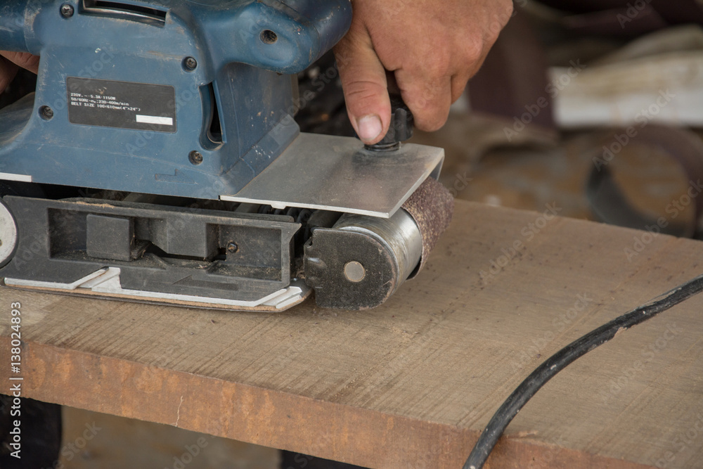working on the electric wood sanding machine working on the electric wood sanding machine